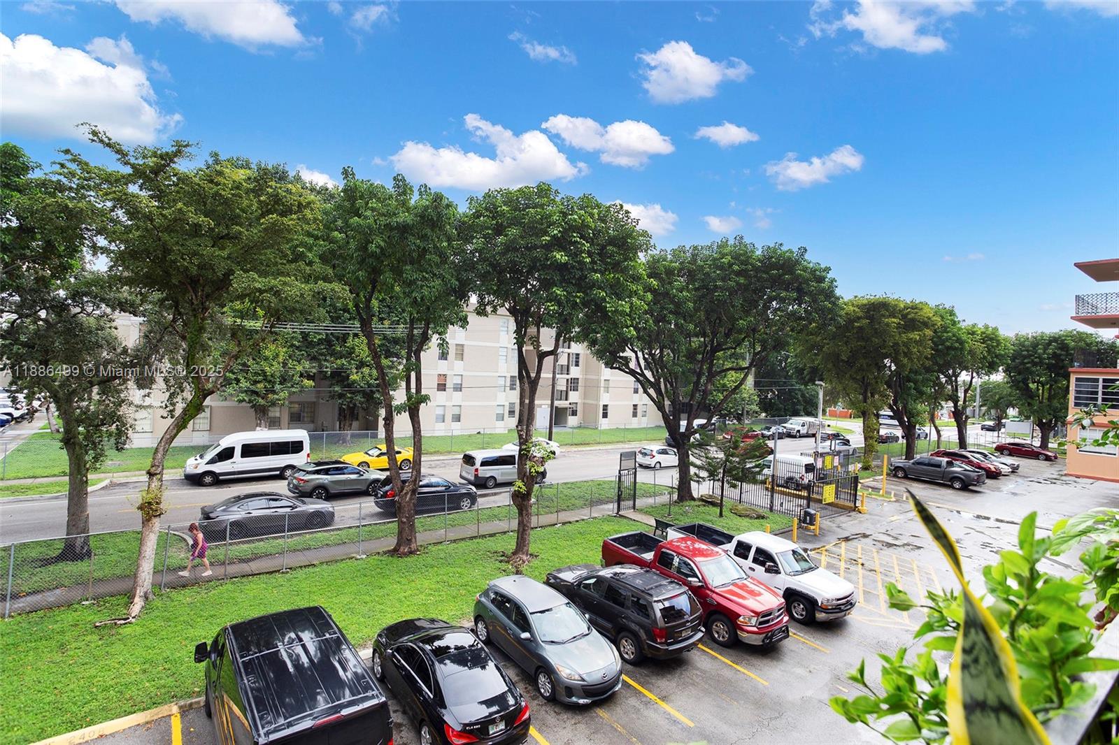 1850 West 56th Street, Unit 2207 Hialeah, FL 33012 - Photo 30 of 33 a cars parked in front of a house with a garden