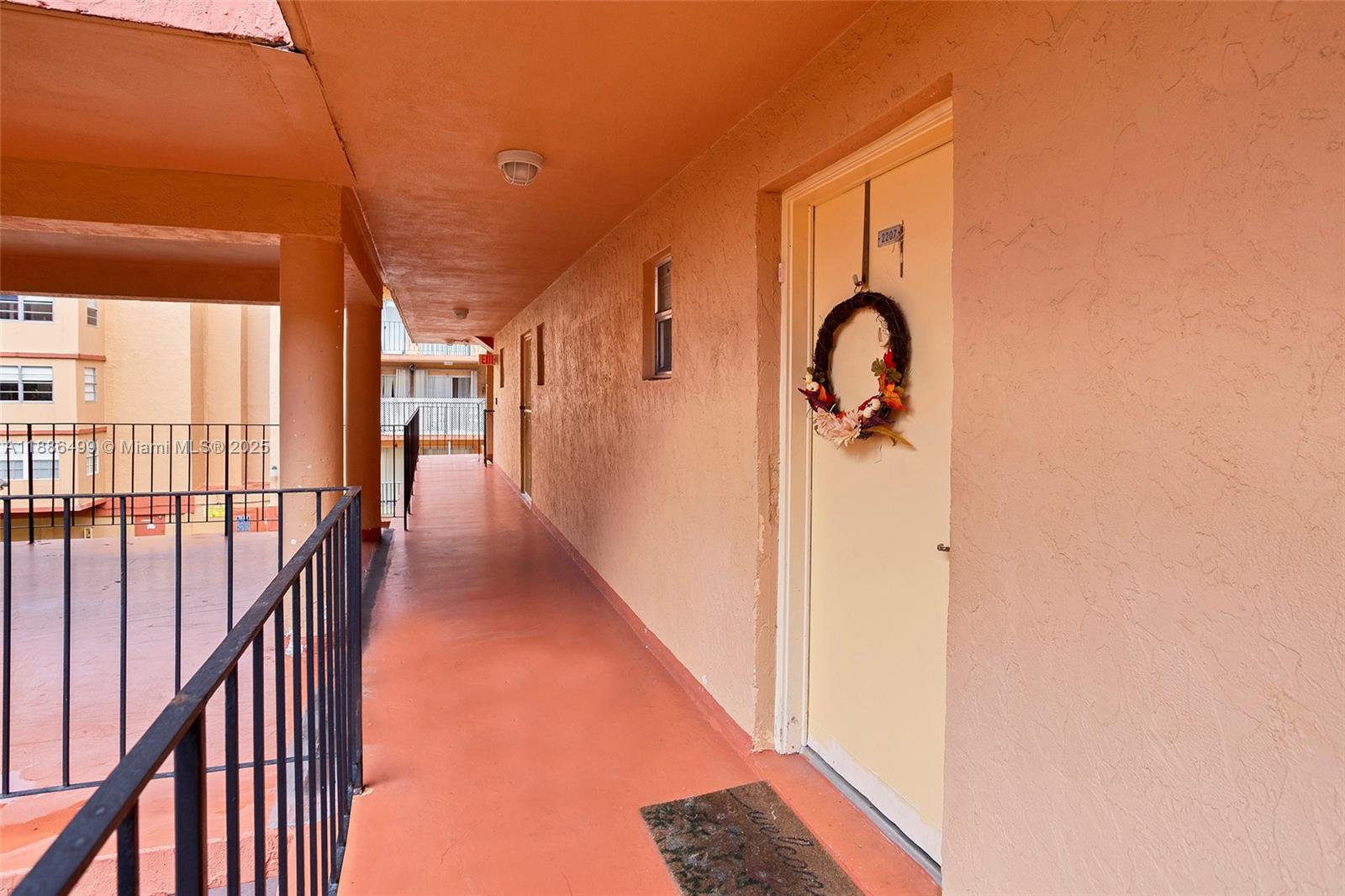 1850 West 56th Street, Unit 2207 Hialeah, FL 33012 - Photo 31 of 33 a view of a hallway with windows