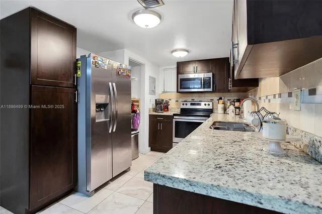 a kitchen with refrigerator and stove