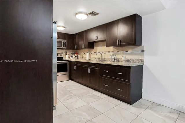 a bathroom with a sink and a large mirror