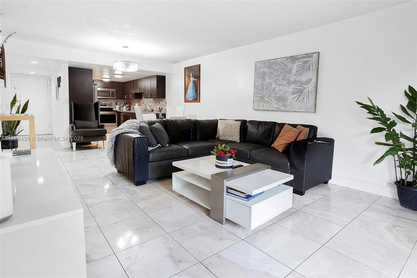 1850 West 56th Street, Unit 2207 Hialeah, FL 33012 - Photo 9 of 33 a living room with furniture and a flat screen tv