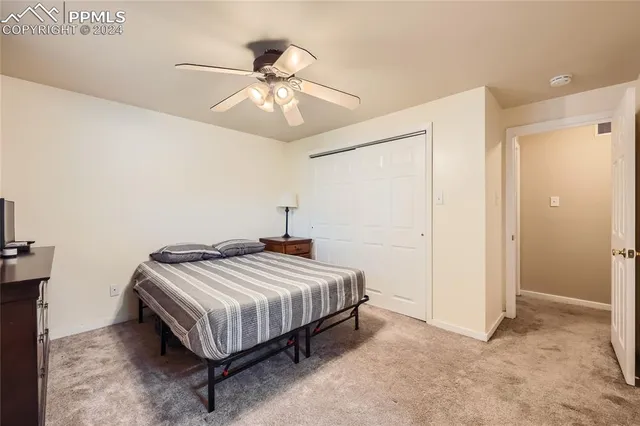 a bedroom with a bed and ceiling fan