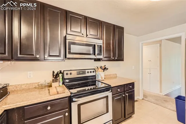 a kitchen with stainless steel appliances granite countertop a sink and a stove