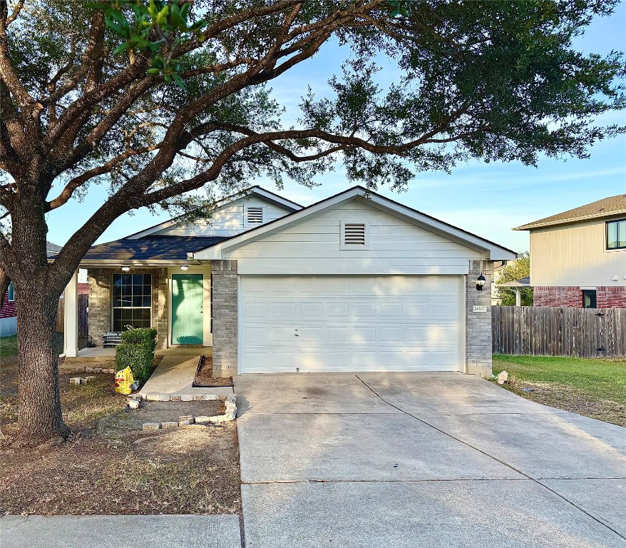 a view of a house with a yard and garage