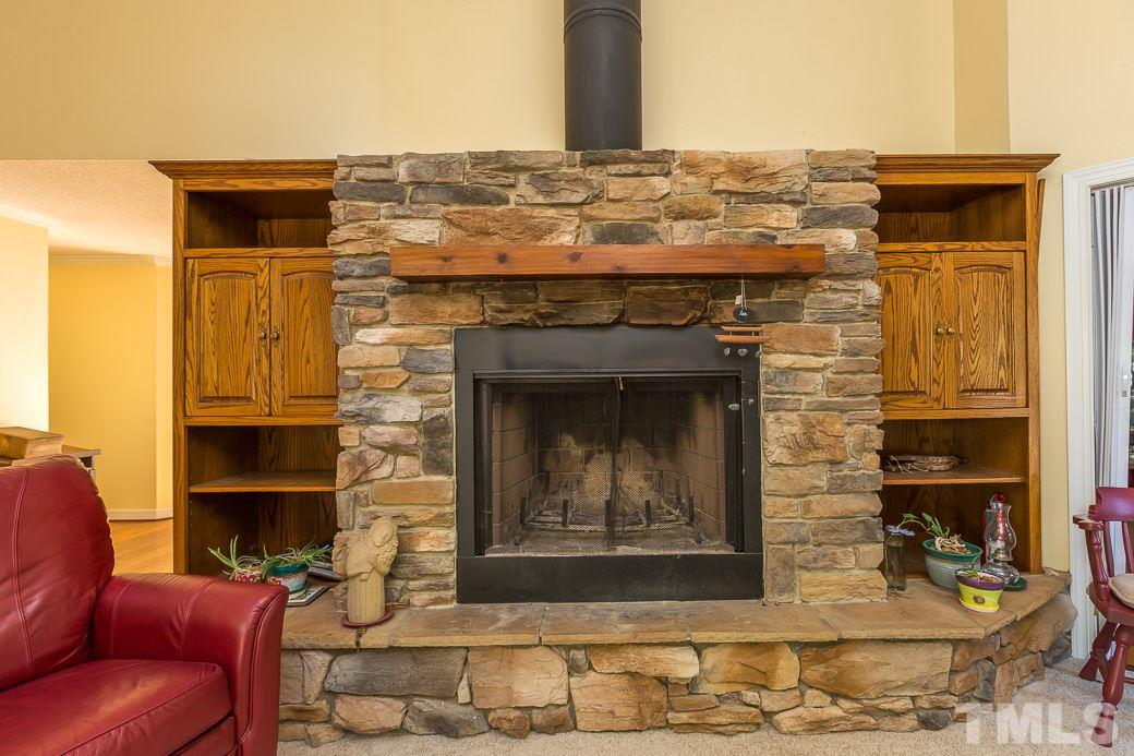 4004 Sherlock Court Raleigh, NC 27613 - Photo 4 of 11 CUSTOM MASONRY FIREPLACE is complimented by custom built-ins. NEW CARPETS complete this room that is ready for you to come get cozy in this winter!