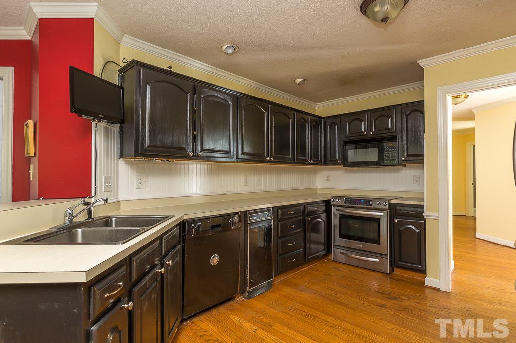 4004 Sherlock Court Raleigh, NC 27613 - Photo 6 of 11 Open kitchen boasts HARDWOOD FLOORS, FRESHLY PAINTED CABINETS, and a LARGE LAUNDRY ROOM off of the side that has TONS OF STORAGE.