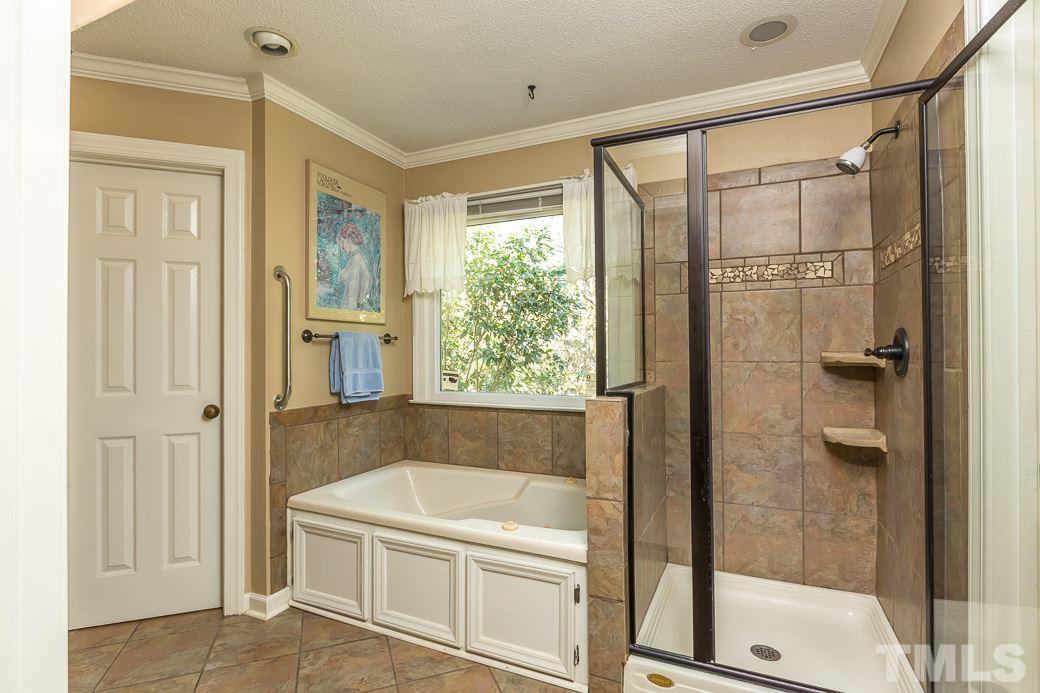4004 Sherlock Court Raleigh, NC 27613 - Photo 8 of 11 MASTER BATHROOM features both a SOAKING TUB and a GLASS SHOWER for a luxurious experience!