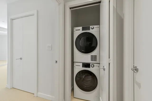 a view of a hallway with washer and dryer