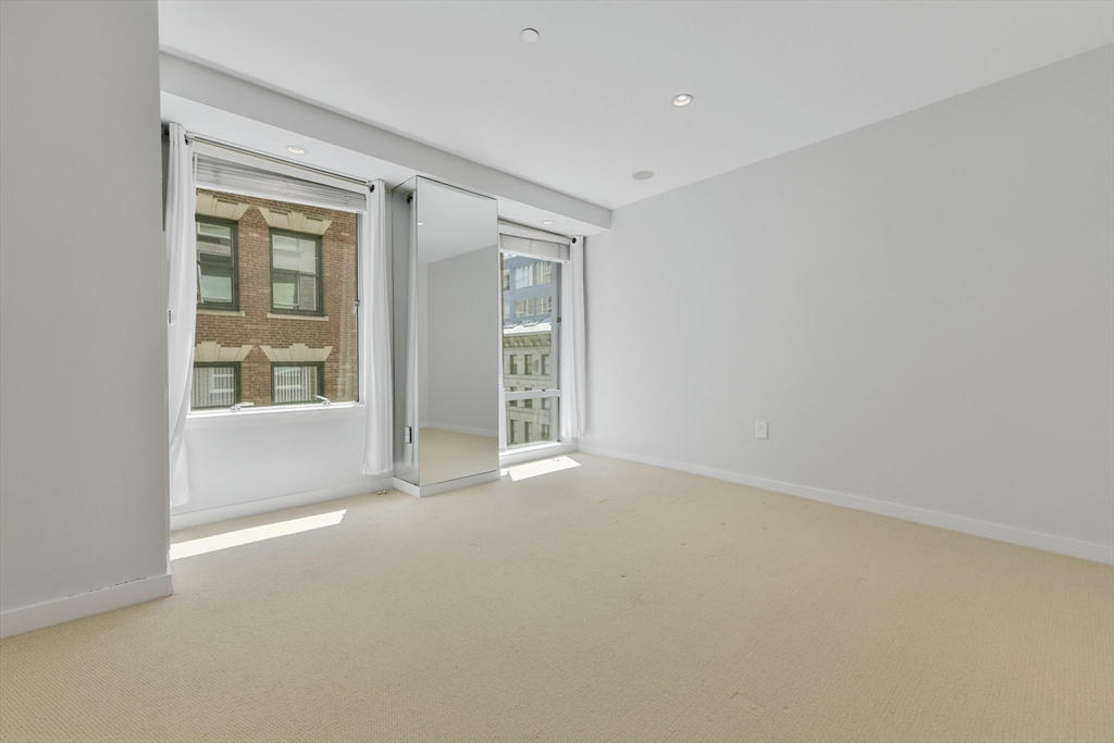 80 Broad Street, Unit 603 Boston, MA 02110 - Photo 10 of 16 an empty room with windows