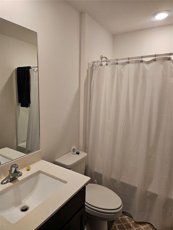 2309 Rio Grande Forest Lane Kissimmee, FL 34759 - Photo 11 of 12 a bathroom with a sink and a mirror