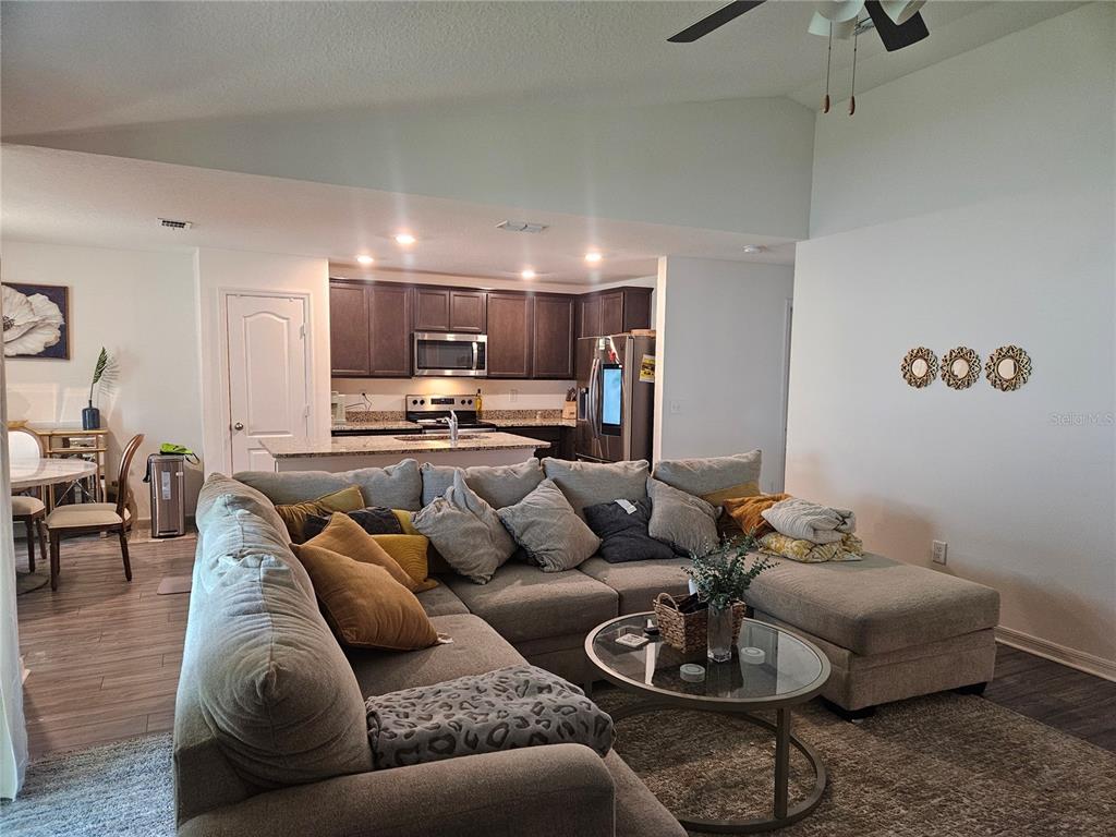 2309 Rio Grande Forest Lane Kissimmee, FL 34759 - Photo 2 of 12 a living room with furniture and kitchen view