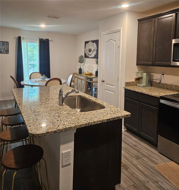 2309 Rio Grande Forest Lane Kissimmee, FL 34759 - Photo 5 of 12 a kitchen with granite countertop kitchen island a sink stove and refrigerator