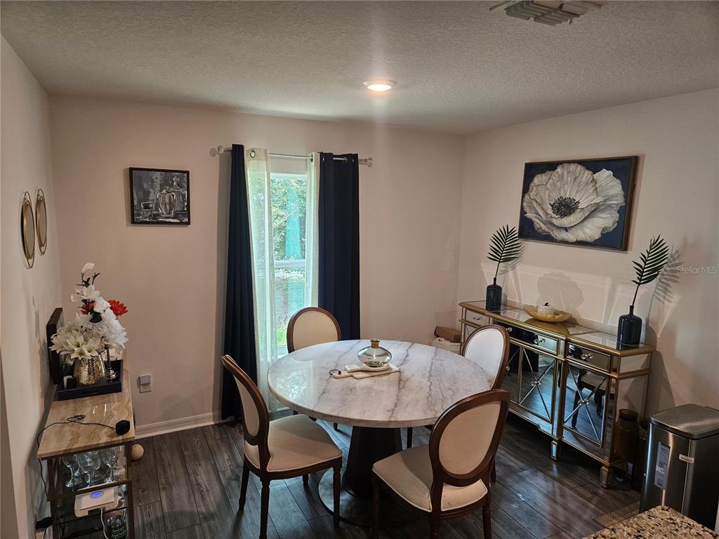 2309 Rio Grande Forest Lane Kissimmee, FL 34759 - Photo 6 of 12 a view of a dining room with furniture and wooden floor