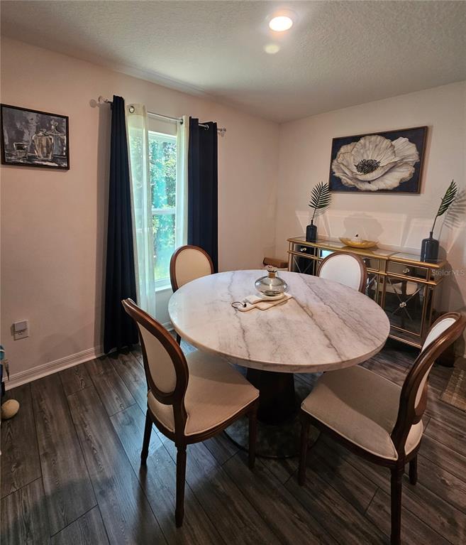 2309 Rio Grande Forest Lane Kissimmee, FL 34759 - Photo 7 of 12 a view of a dining room with furniture window and wooden floor