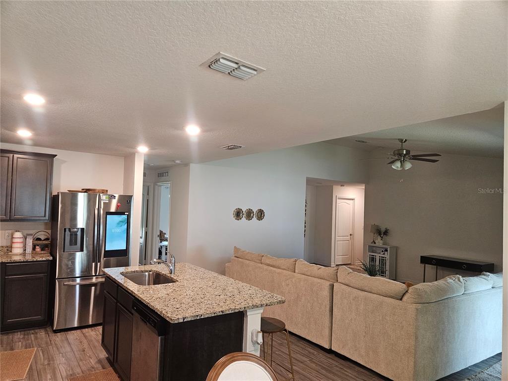 2309 Rio Grande Forest Lane Kissimmee, FL 34759 - Photo 8 of 12 a living room with furniture and a table