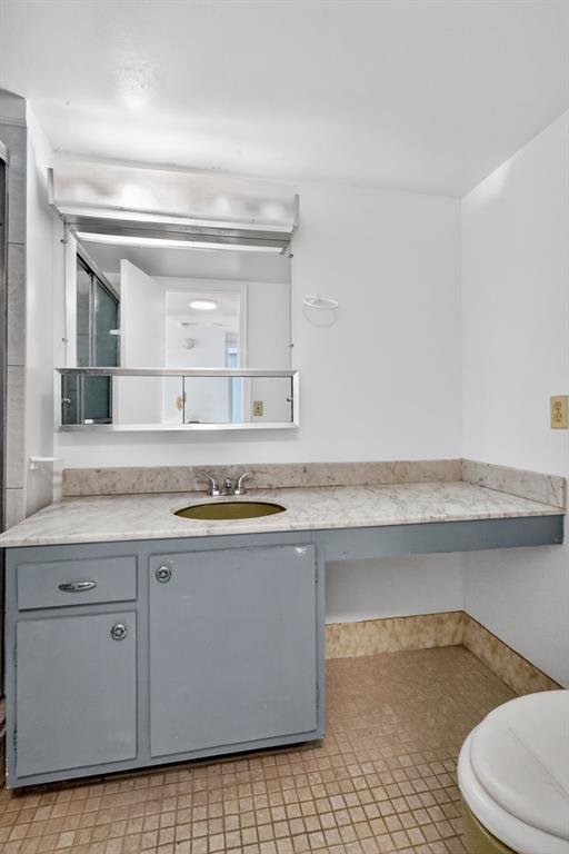 2750 Northeast 183rd Street, Unit 911 Aventura, FL 33160 - Photo 12 of 34 a bathroom with granite countertop a sink and a mirror