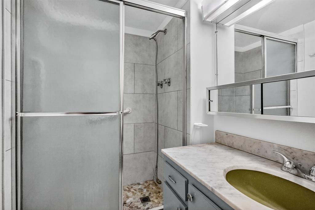 2750 Northeast 183rd Street, Unit 911 Aventura, FL 33160 - Photo 13 of 34 a bathroom with a granite countertop sink a mirror and shower