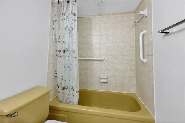 a bathroom with a tub and shower