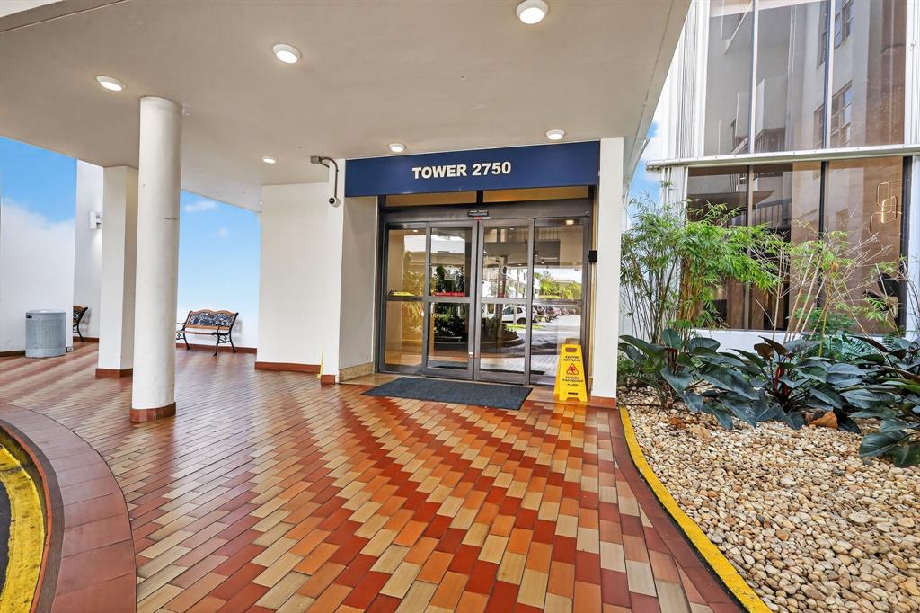 2750 Northeast 183rd Street, Unit 911 Aventura, FL 33160 - Photo 2 of 34 a lobby with furniture and floor to ceiling window