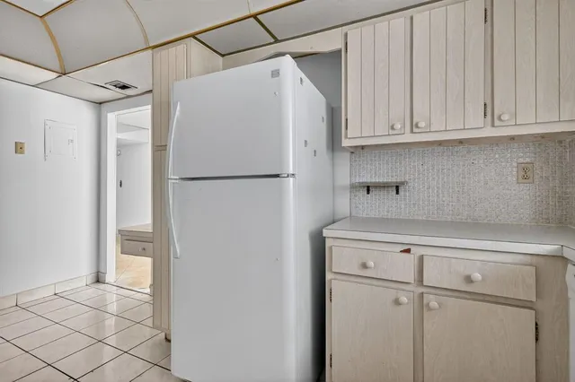 a white refrigerator freezer sitting inside of a kitchen