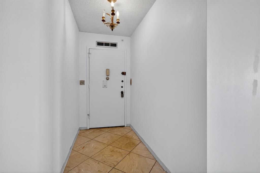 2750 Northeast 183rd Street, Unit 911 Aventura, FL 33160 - Photo 10 of 34 a view of an entryway with a chandelier