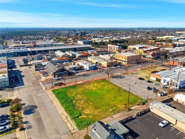 a view of swimming pool with lawn chairs and a big yard