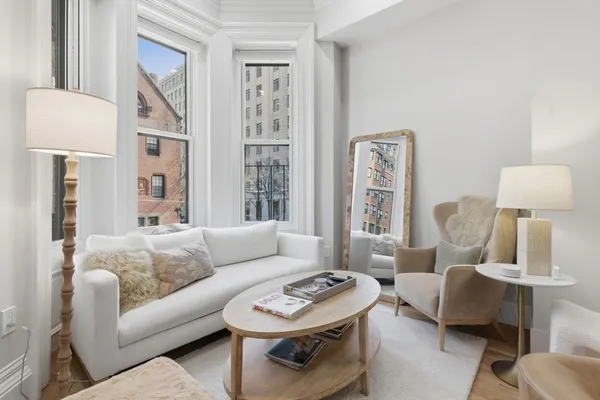 a living room with furniture and a painting