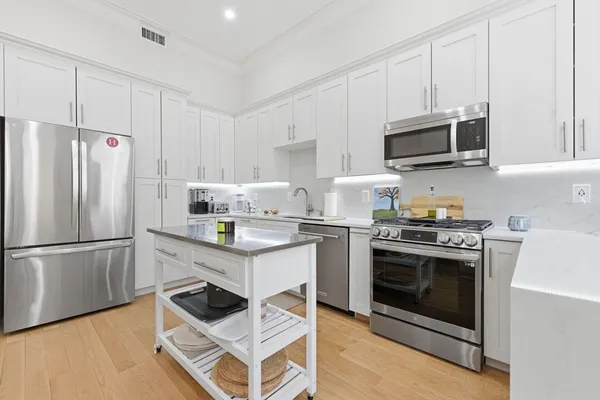 a kitchen with stainless steel appliances a stove a microwave and a refrigerator