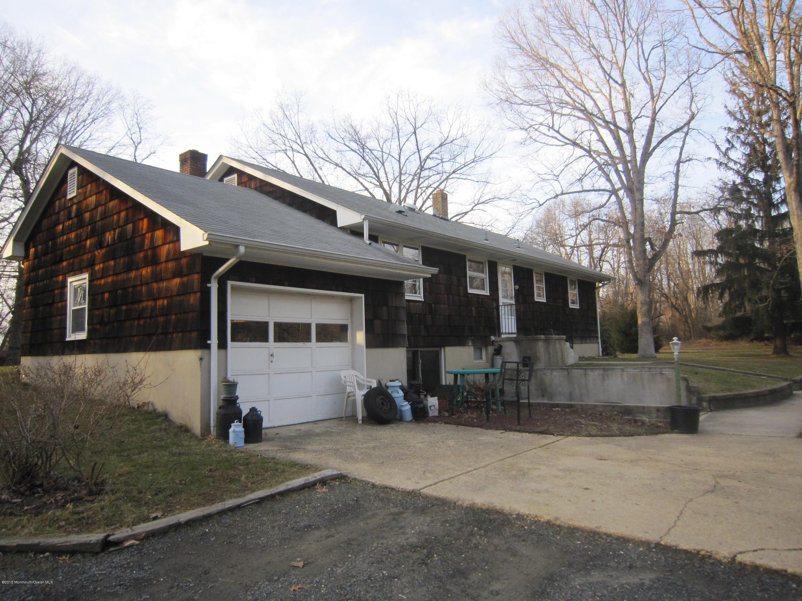 343 Colts Neck Road Farmingdale, NJ 07727 - Photo 2 of 3 a front view of a house with a yard and garage