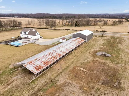 swimming pool with an outdoor seating and a lake view