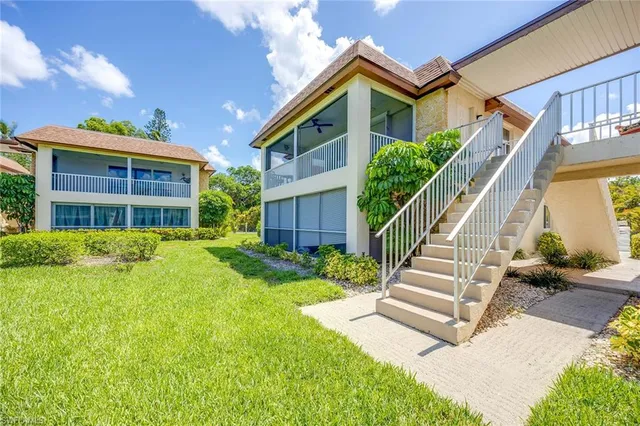 a view of house with yard and front view of a house