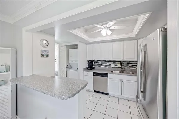 a kitchen with a stove a sink and a refrigerator