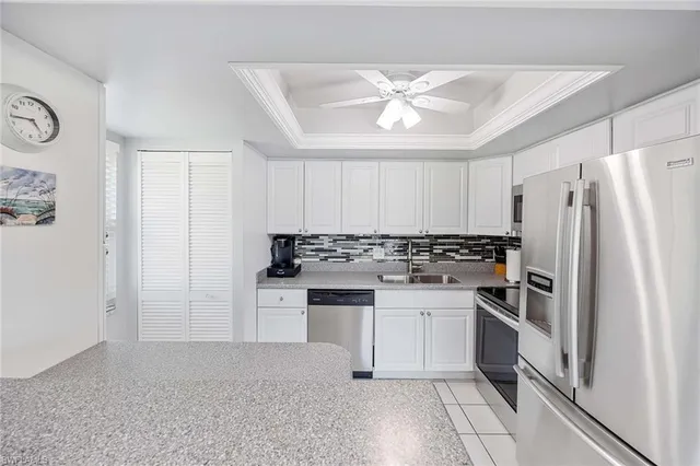 a kitchen with a refrigerator and a sink