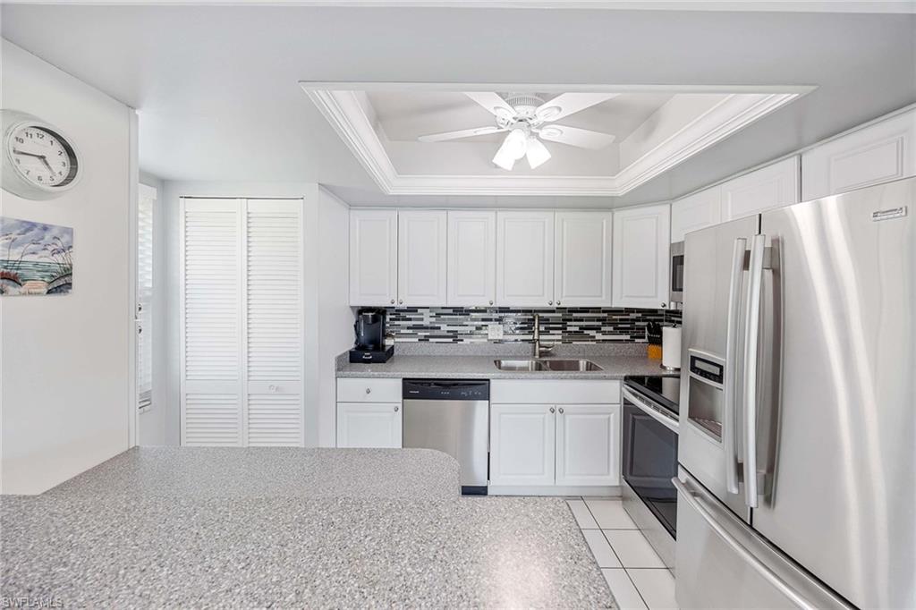 1155 Sandpiper Street, Unit G6 Naples, FL 34102 - Photo 9 of 30 a kitchen with a refrigerator and a sink
