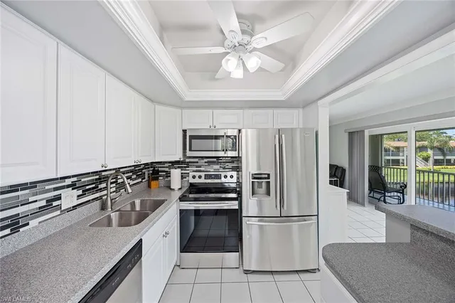 a kitchen with stainless steel appliances a refrigerator a stove a sink and a refrigerator