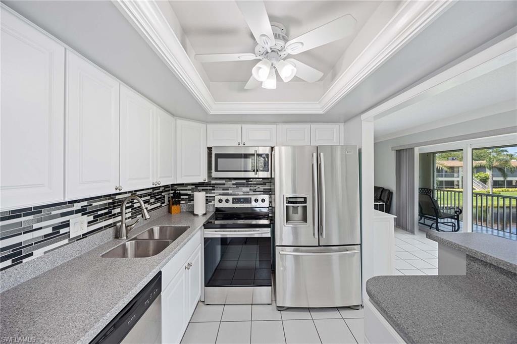 1155 Sandpiper Street, Unit G6 Naples, FL 34102 - Photo 10 of 30 a kitchen with stainless steel appliances a refrigerator a stove a sink and a refrigerator