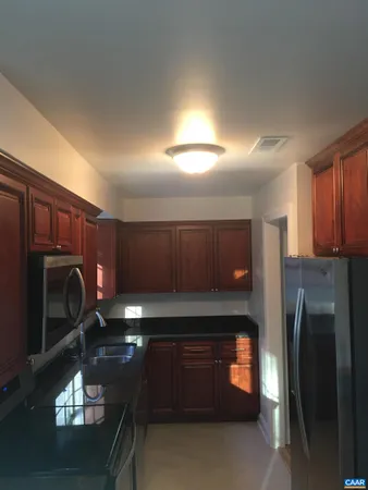 a kitchen with a refrigerator and a microwave