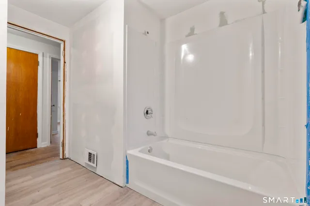 a bathroom with a bathtub and a shower