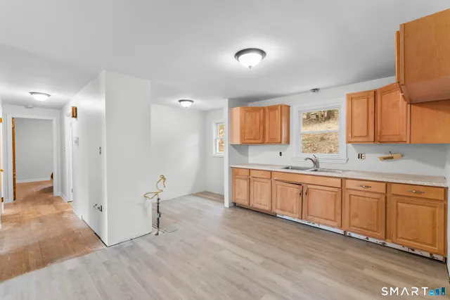 a large kitchen with stainless steel appliances granite countertop a sink and cabinets