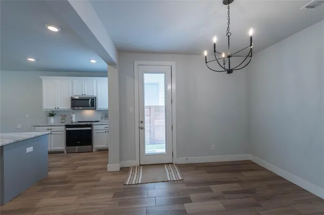 a view of a kitchen with a sink wooden floor and a window
