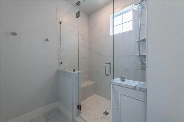 a bathroom with a granite countertop toilet a sink and shower