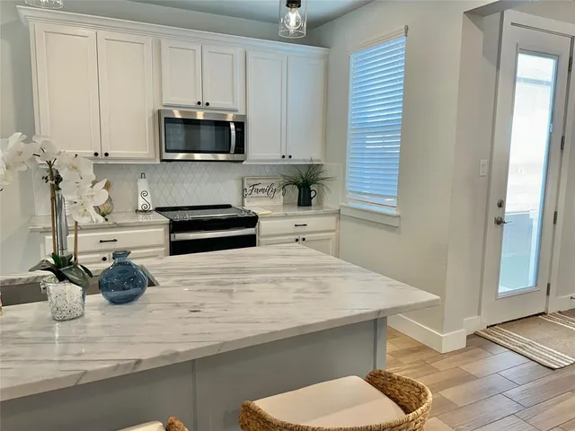 a kitchen with a sink a microwave and cabinets