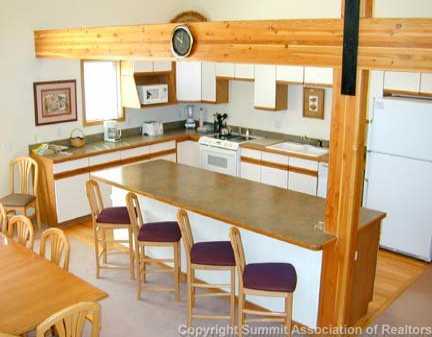 56 View Lane, Unit 7F Breckenridge, CO 80424 - Photo 3 of 16 a kitchen with a table and chairs in it