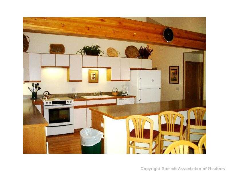 56 View Lane, Unit 7F Breckenridge, CO 80424 - Photo 4 of 16 a kitchen with stainless steel appliances granite countertop a stove and a sink