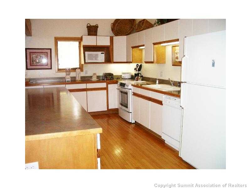 56 View Lane, Unit 7F Breckenridge, CO 80424 - Photo 5 of 16 a kitchen with stainless steel appliances granite countertop a sink and a stove