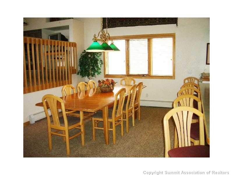 56 View Lane, Unit 7F Breckenridge, CO 80424 - Photo 7 of 16 a dining room with furniture and a chandelier