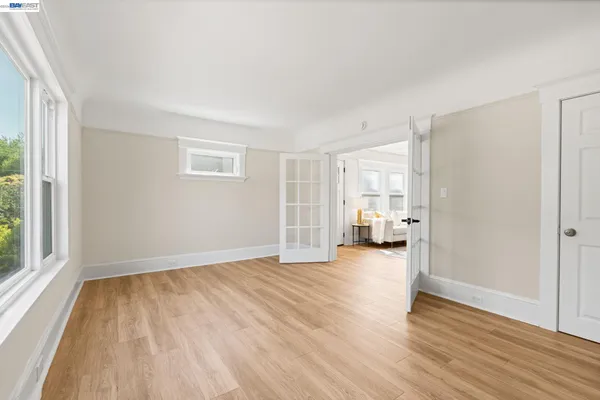an empty room with windows and closet