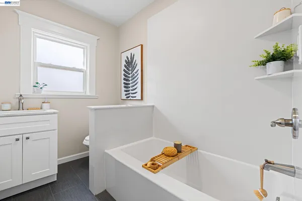 a living room with furniture a fireplace and a potted plant