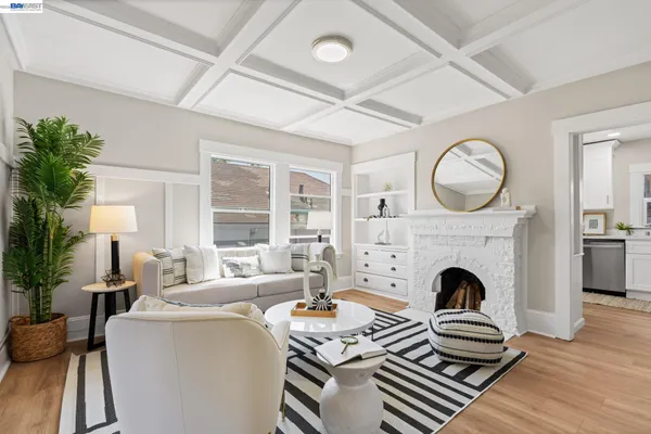 a living room with furniture a fireplace and a floor to ceiling window