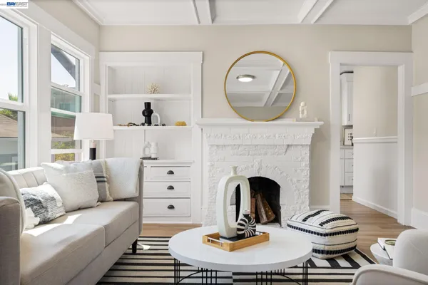 a kitchen with white cabinets and sink